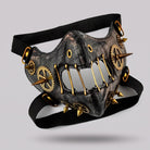 Black and gold steampunk half mask with gears, spikes, and metal teeth | Chaps London