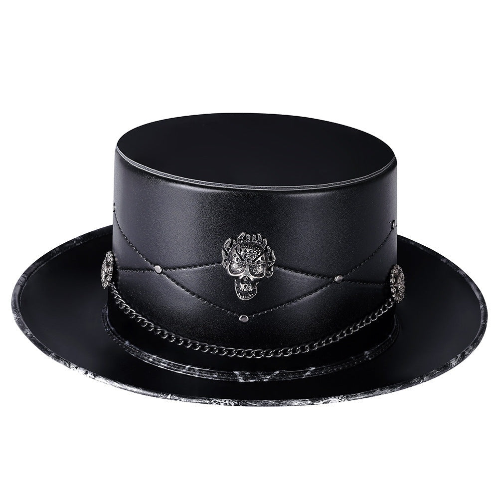 Black gothic top hat with skull emblem, chain, and studs, flat-laid | Chaps London