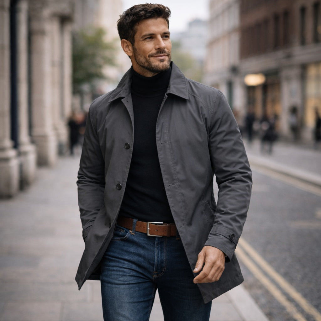 Man wearing gray rain mac jacket over black turtleneck and jeans | Chaps London