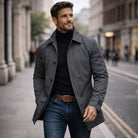 Man wearing gray rain mac jacket over black turtleneck and jeans | Chaps London