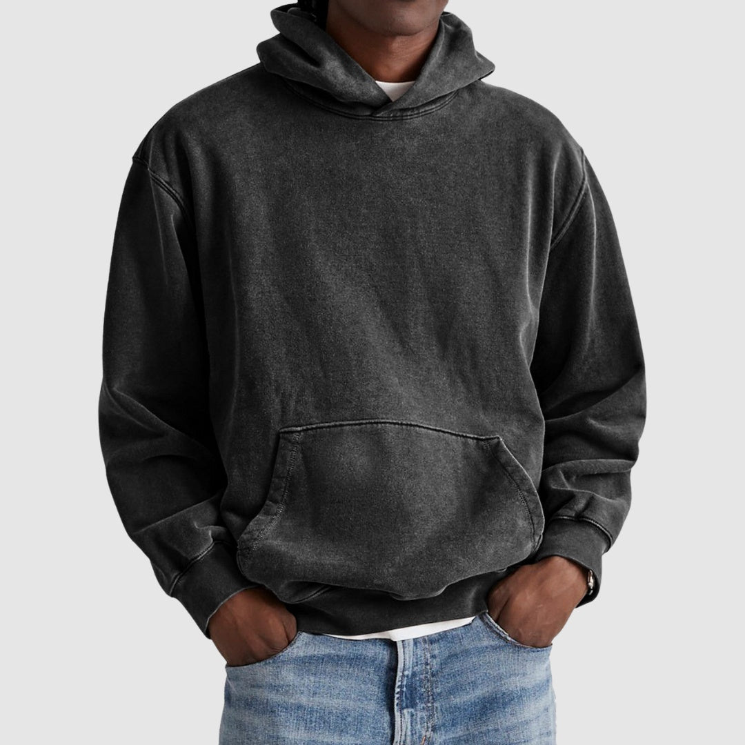 Man wearing oversized washed black hoodie with kangaroo pocket and jeans | Chaps London