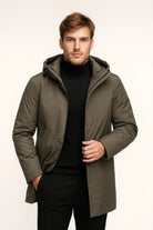 Man wearing olive green hooded parka with black turtleneck and trousers | Chaps London