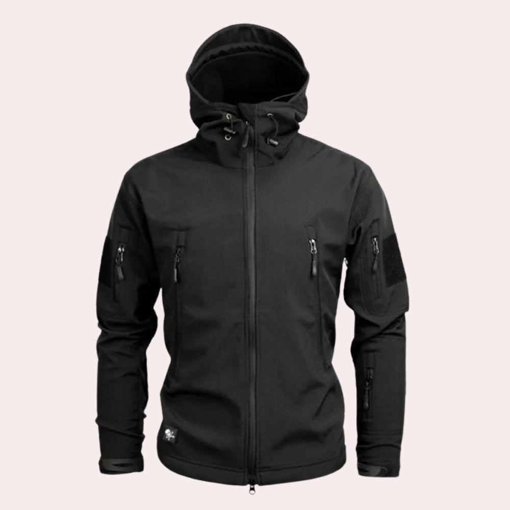 Black hooded softshell jacket with zip pockets, worn by a person | Chaps London