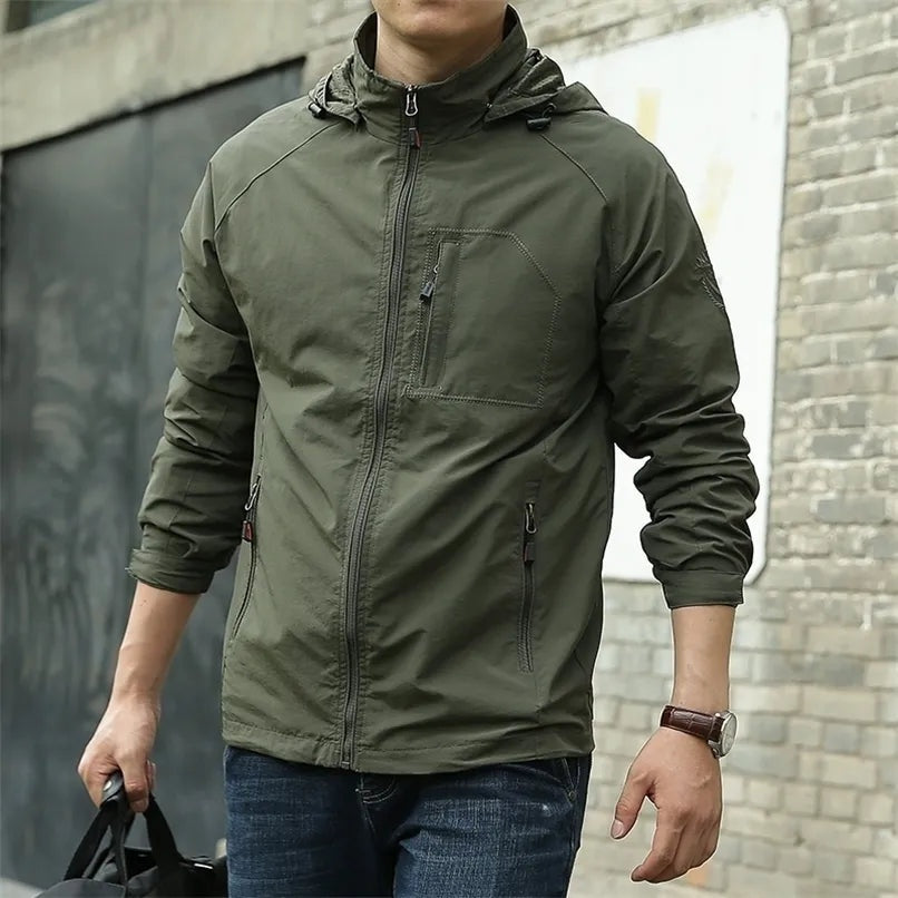 Man wearing olive green hooded jacket with zippered pockets, standing outdoors | Chaps London