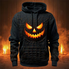 Black hoodie with glowing jack-o'-lantern face and spiderweb print, worn by person | Chaps London