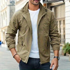 Man wearing olive green hooded jacket with white t-shirt and dark jeans | Chaps London