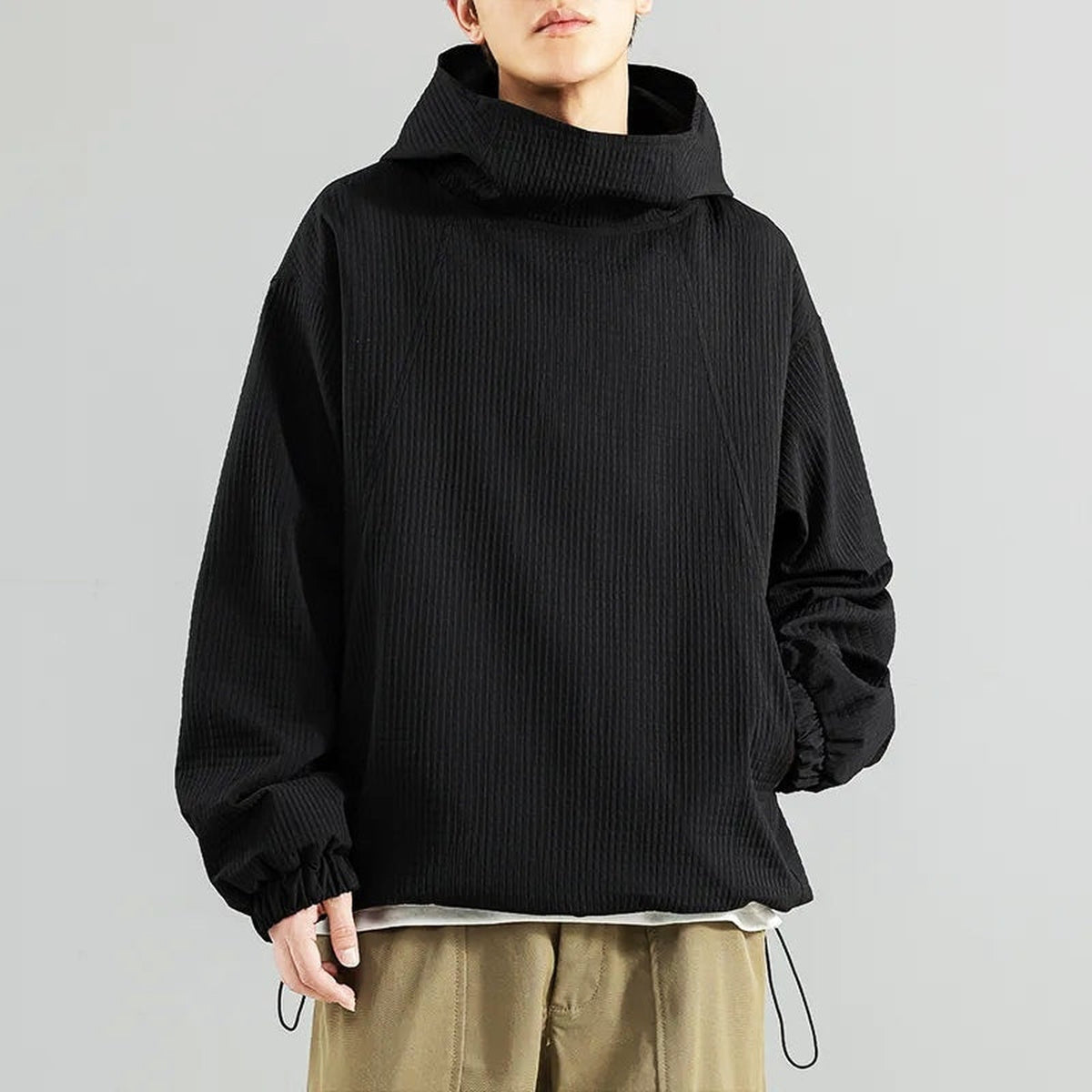 Man wearing black waffle-textured oversized hoodie with funnel neck, drawcord hem | Chaps London