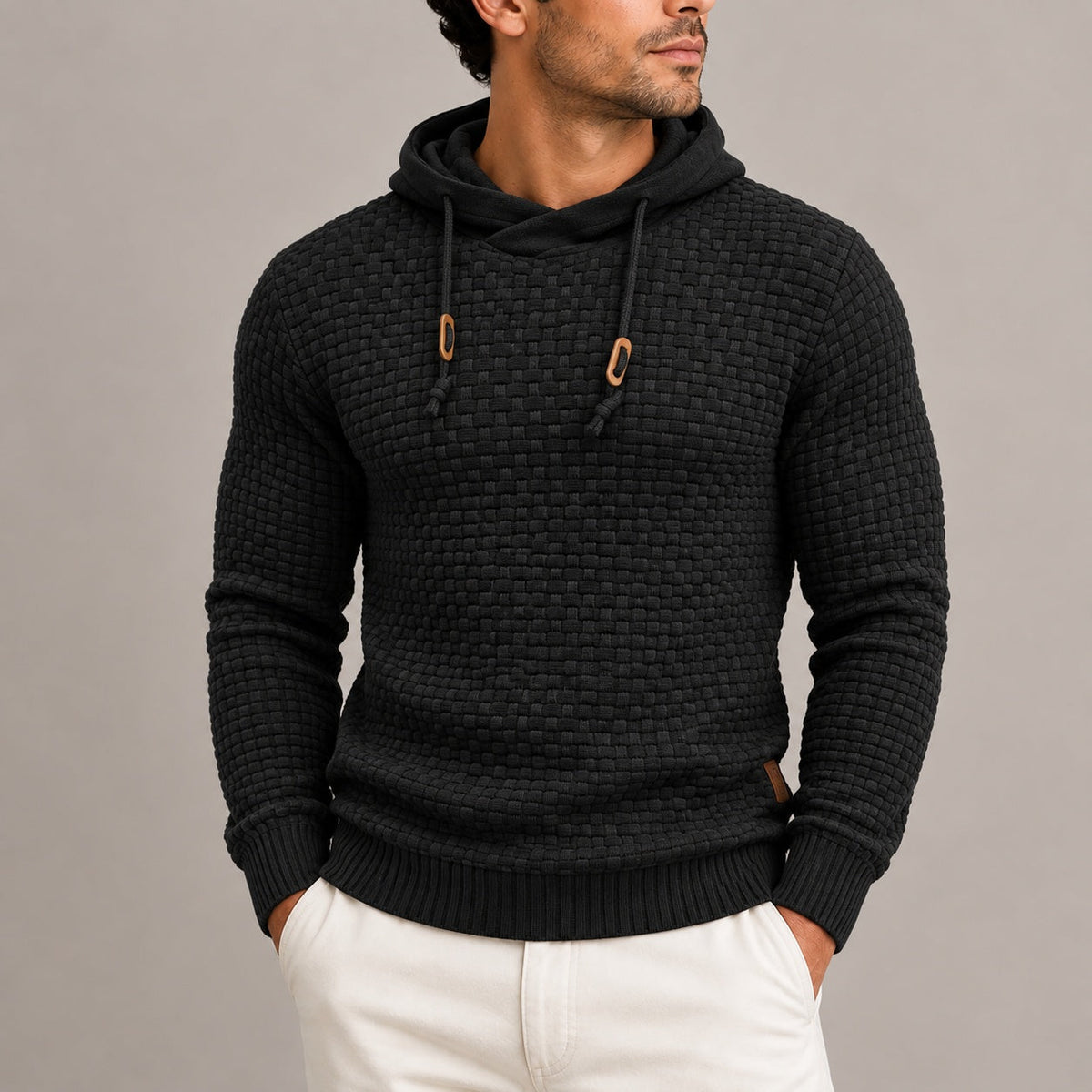 Man wearing black basket weave knit hoodie with wooden toggle drawstrings | Chaps London