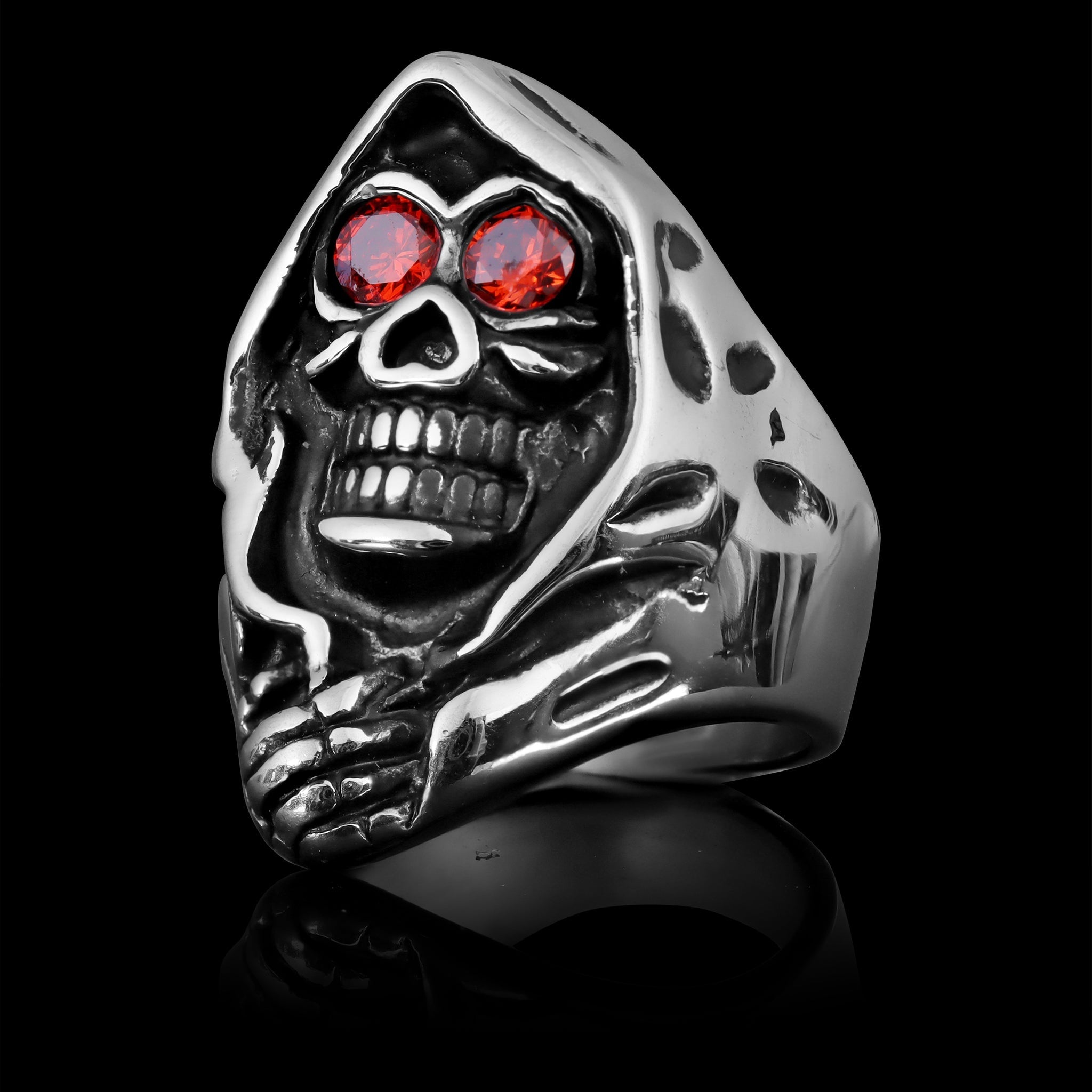 Silver hooded skull ring with red gemstone eyes, shown standing upright | Chaps London