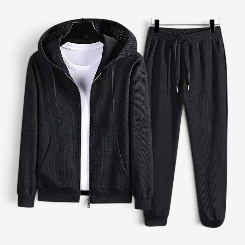 Black zip hoodie and matching joggers on hangers, white shirt underneath | Chaps London
