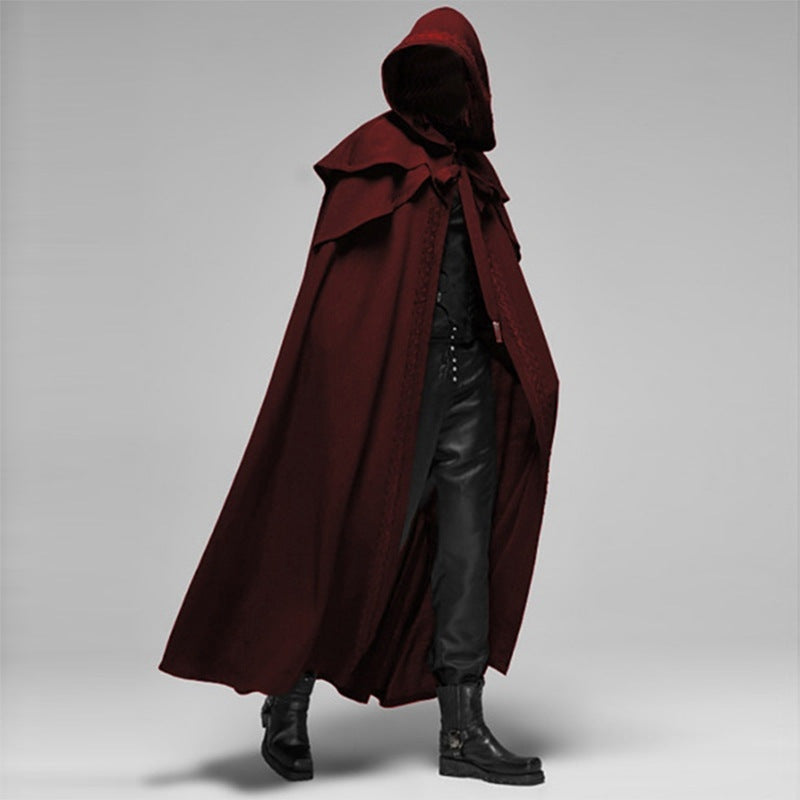Man wearing burgundy hooded cape with black pants, side view | Chaps London