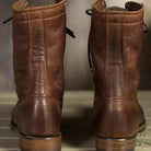 Pair of brown lace-up ankle boots shown from behind on floor | Chaps London