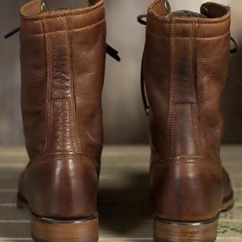 Pair of brown lace-up ankle boots shown from behind on floor | Chaps London