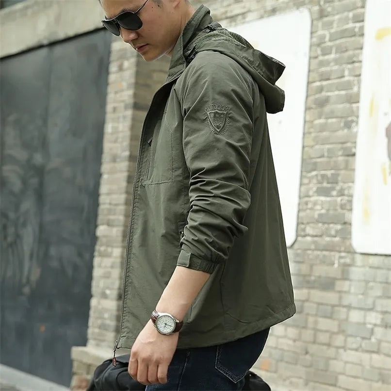 Man wearing olive green hooded jacket with watch, outdoor street setting | Chaps London