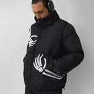 Man wearing black puffer jacket with white skeleton hand graphic design | Chaps London