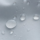 Close-up of water droplets beading on grey waterproof jacket fabric surface | Chaps London
