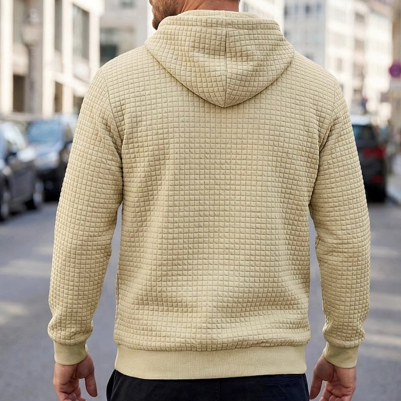 Beige quilted-texture hoodie worn by man, back view, outdoor street setting | Chaps London