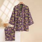 Purple kimono pajama set with green pumpkin print, hung on hanger | Chaps London