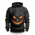 Black hoodie with glowing orange jack-o'-lantern face and spiderweb texture, worn by person | Chaps London
