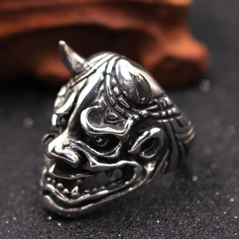 Silver-toned Oni demon mask ring with horns, displayed flat | Chaps London
