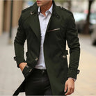 Man wearing dark green trench coat with epaulettes, standing outdoors on sidewalk | Chaps London