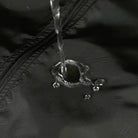 Water droplets beading on black water-repellent fabric near zipper seam | Chaps London