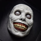 White smiling demon mask with sunken eyes and bloody teeth, flat display | Chaps London