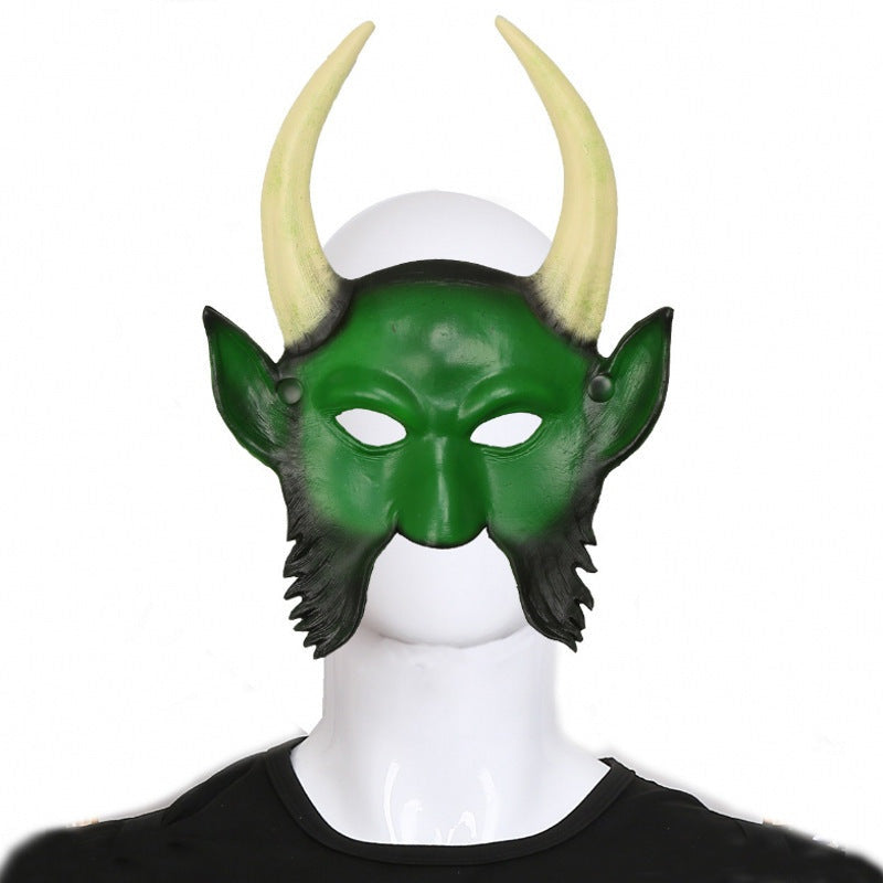 Green half mask with curved horns and beard, worn by a person | Chaps London