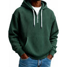 Man wearing green ribbed half-zip hoodie with drawstring hood and pocket | Chaps London
