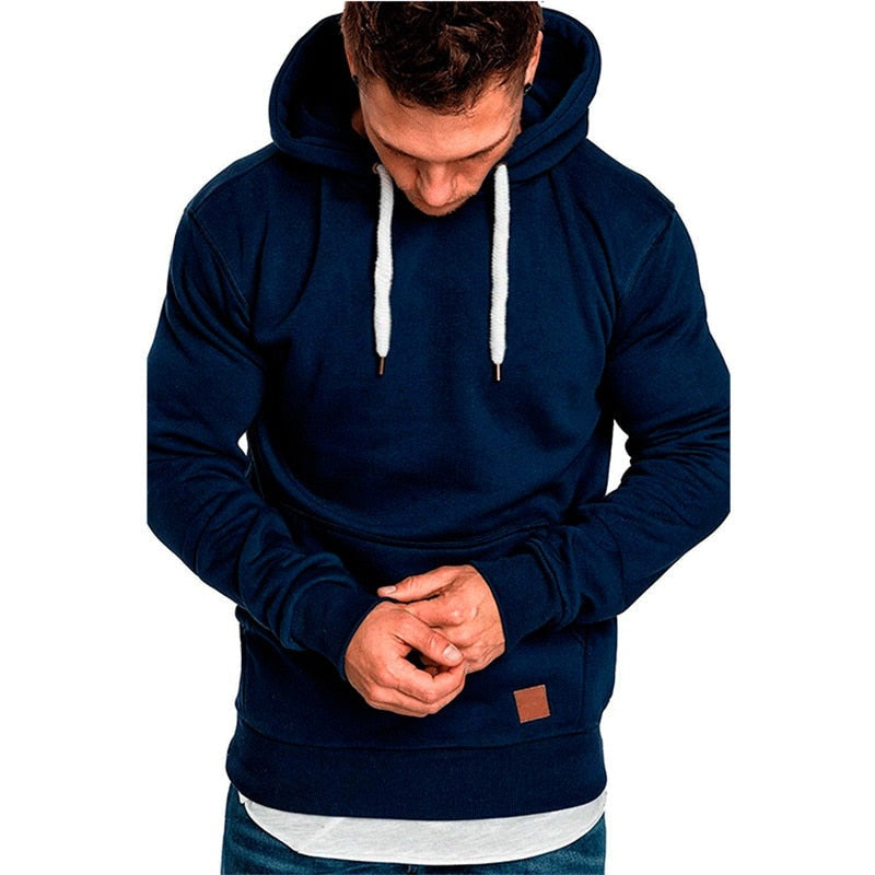 Navy blue hoodie worn by man, layered hem, drawstring hood, patch detail | Chaps London