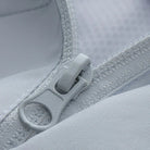 Close-up of white jacket zipper pull and fabric texture detail | Chaps London