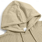 Beige quilted hoodie close-up showing hood, drawstrings, and care label detail | Chaps London