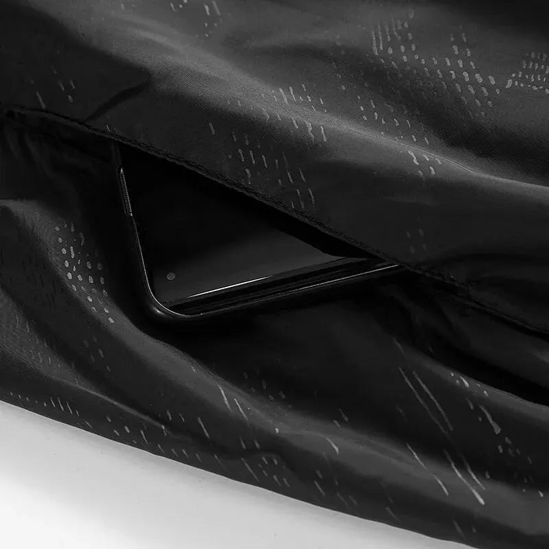 Black patterned jacket fabric with hidden pocket holding a smartphone | Chaps London
