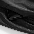Black patterned jacket fabric with hidden pocket holding a smartphone | Chaps London