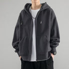 Dark gray oversized zip hoodie worn by man, drawstrings and chain visible | Chaps London