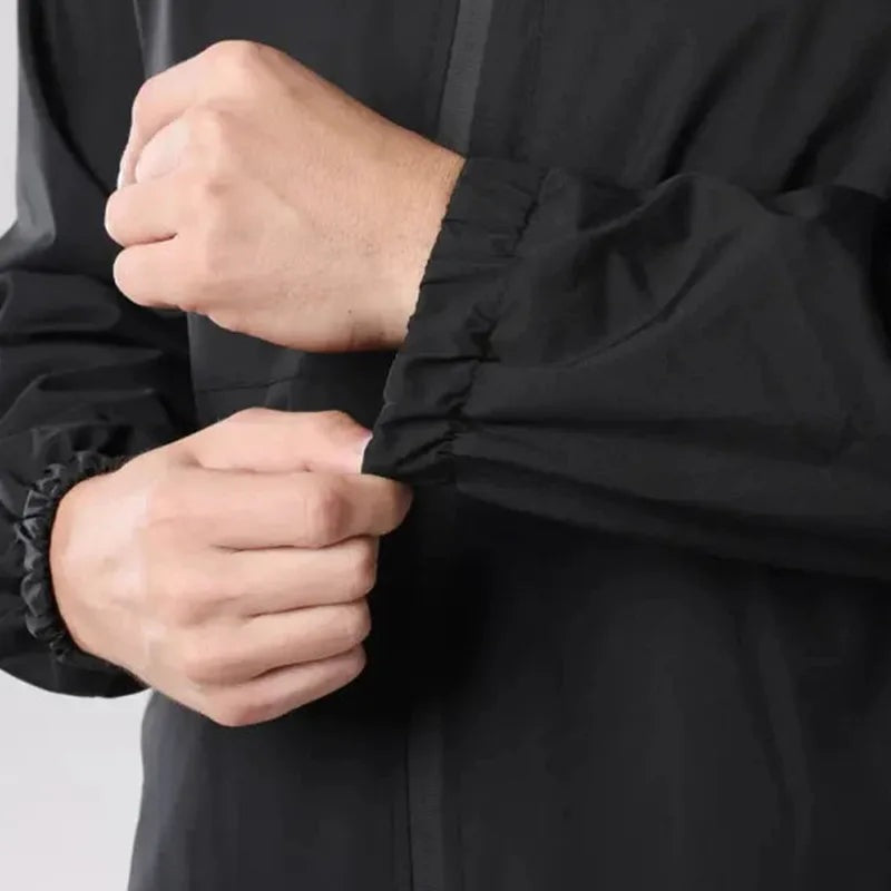 Close-up of black rain jacket sleeve cuff worn by person on arm | Chaps London