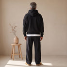 Man wearing black hoodie and matching black joggers, rear view | Chaps London