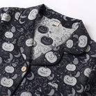 Black pyjama shirt collar close-up with pumpkin and ghost print pattern | Chaps London