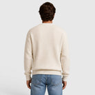 Man wearing cream ribbed knit crew neck sweater, back view, paired with jeans | Chaps London