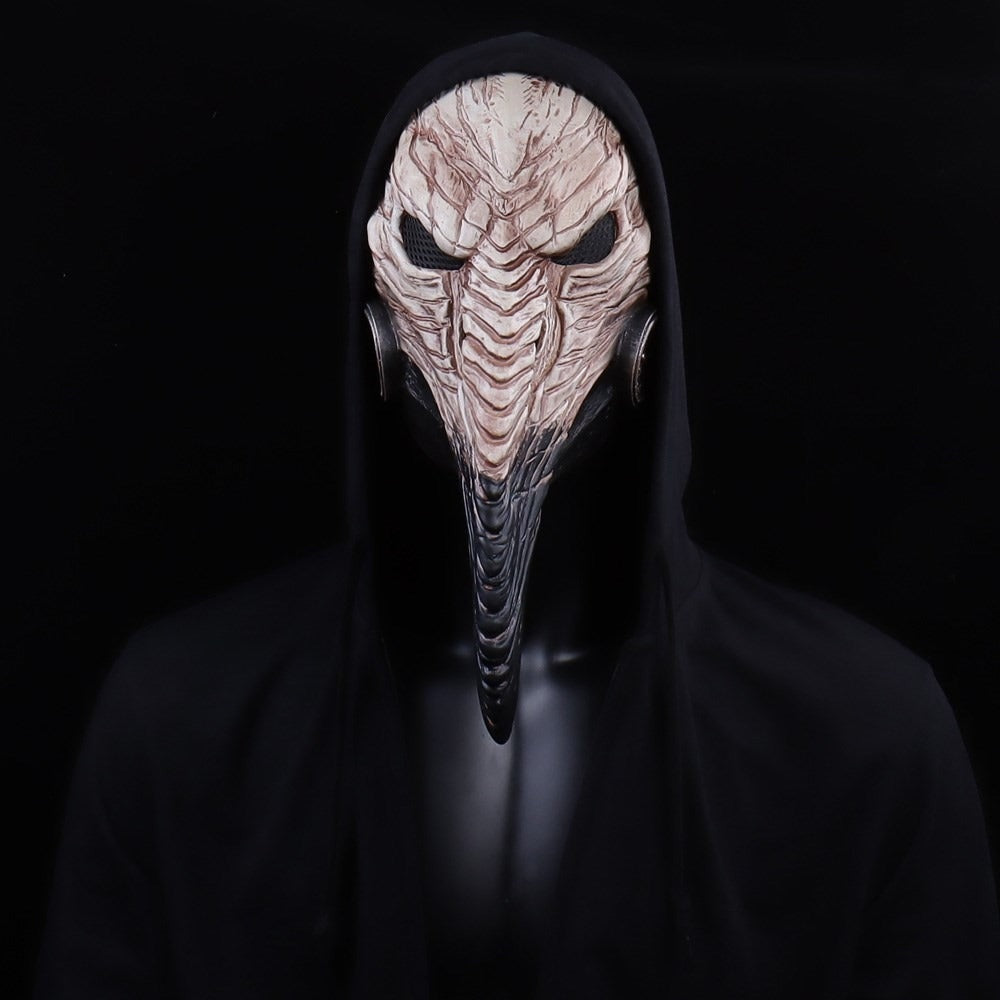 Black-and-white raven-beaked plague doctor mask worn by hooded person, front view | Chaps London