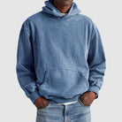 Man wearing oversized washed blue hoodie with kangaroo pocket, paired with jeans | Chaps London