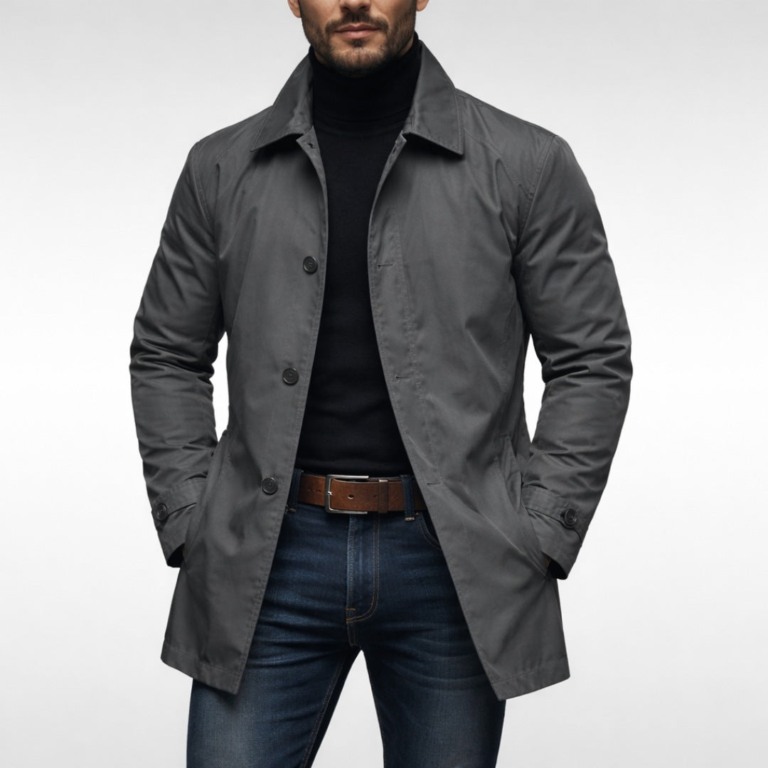 Man wearing gray button-front mac coat over black turtleneck and jeans | Chaps London