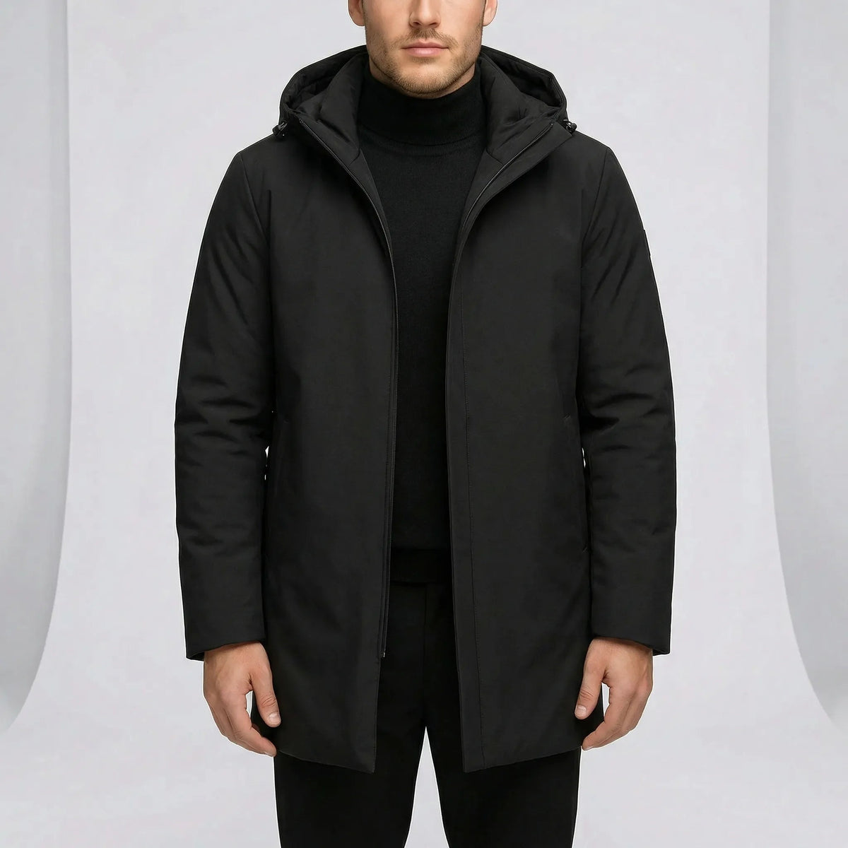 Black hooded coat with concealed zip worn by man, mid length | Chaps London