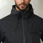 Black hooded rain jacket with zip pocket worn by man, close-up view | Chaps London