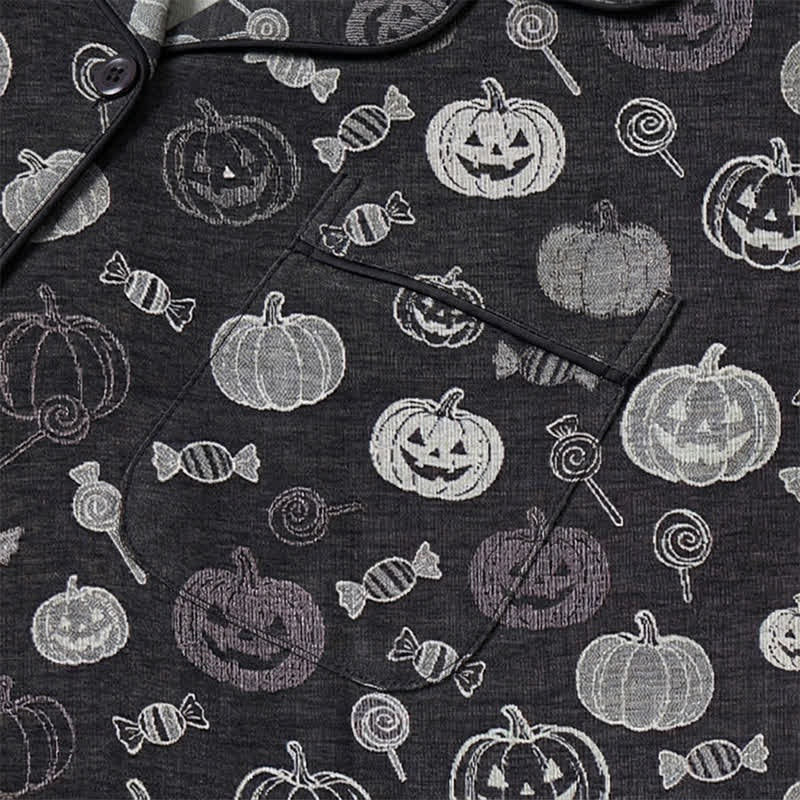 Black pyjama set with pumpkin and candy print, worn, close-up view | Chaps London