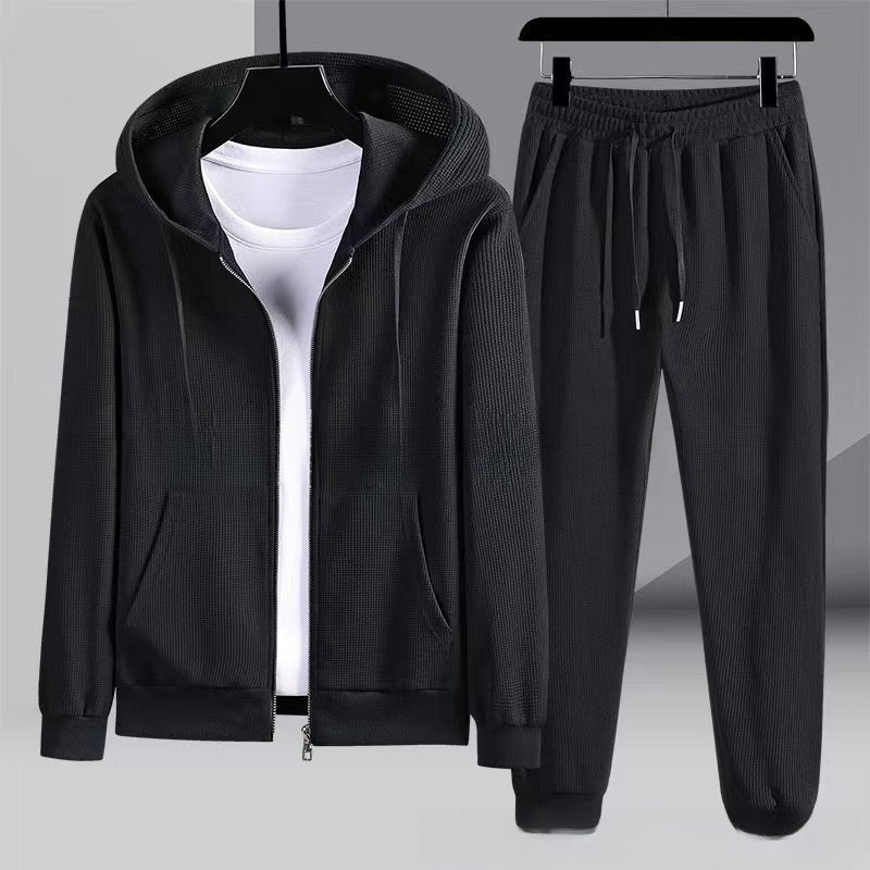 Black waffle-textured zip hoodie and matching jogger pants, flat on hangers | Chaps London