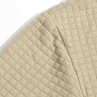 Close-up of beige quilted fabric showing hood and shoulder seam detail | Chaps London