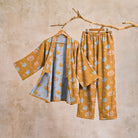 Mustard kimono pyjama set with ghost and pumpkin print, hung on branch | Chaps London