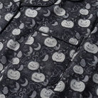 Black pyjama fabric with pumpkin, ghost and bat print, shown flat | Chaps London