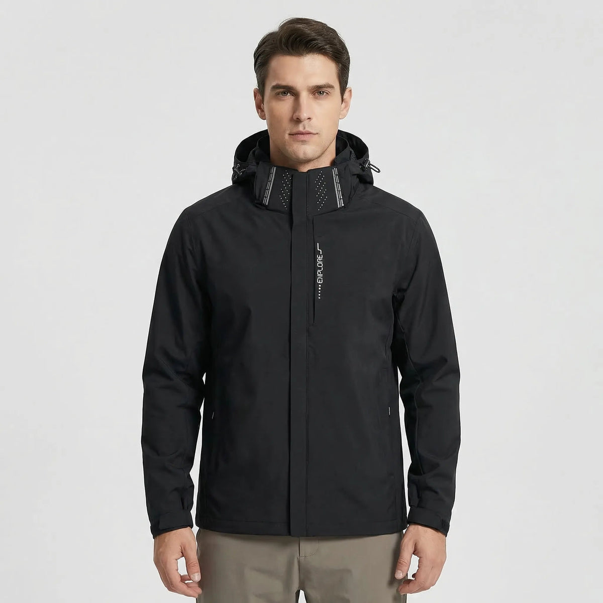 Man wearing black hooded rain jacket with zip pockets, worn standing | Chaps London